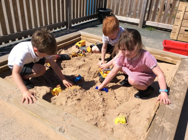 children playing in sandpit