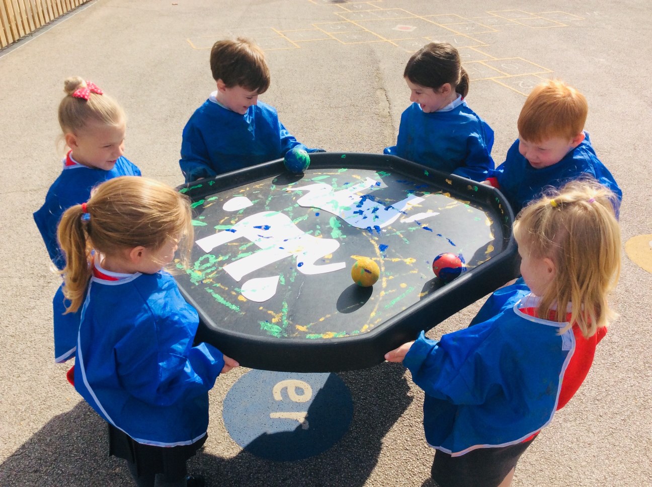 children playing with ball and paint